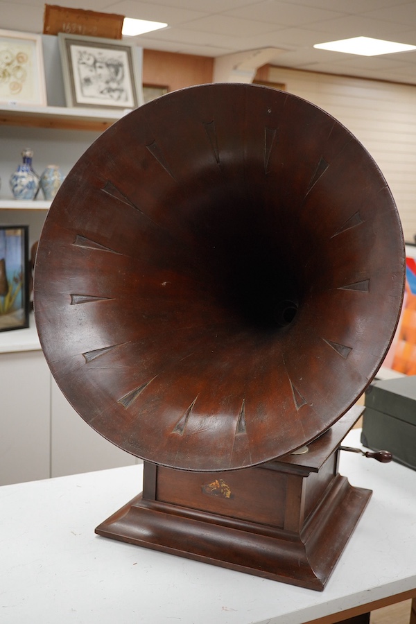 An HMV tabletop mahogany gramophone player with large laminated wooden horn, diameter of horn 55cm. HMV transfer labels to both body and horn. Condition - fair.